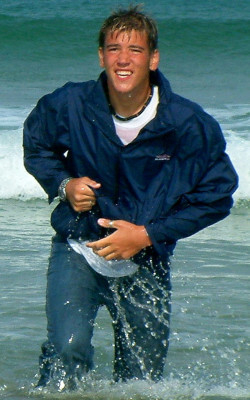 anorak blue jeans swimming fully clothed on beach